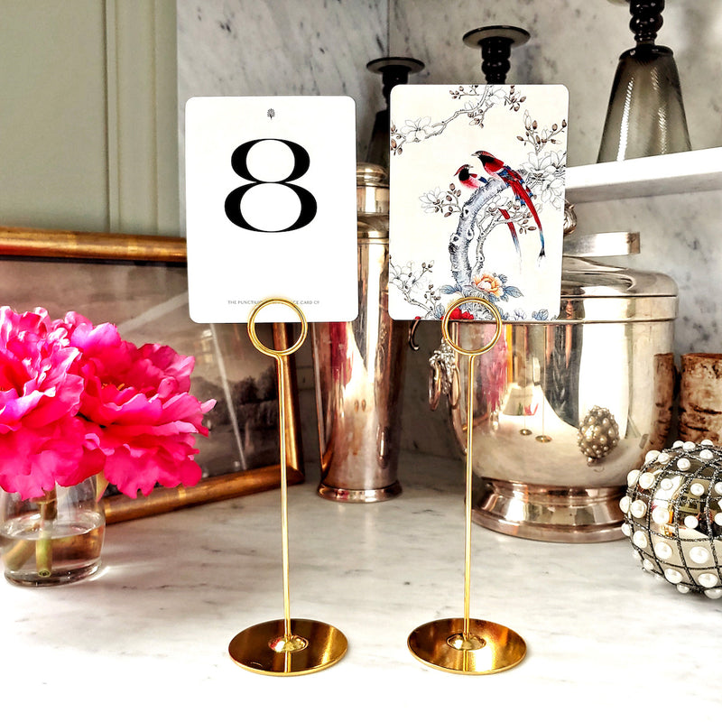 The Punctilious Mr. P's Place Card Co. custom Wedding Table Number cards on a tall gold stand