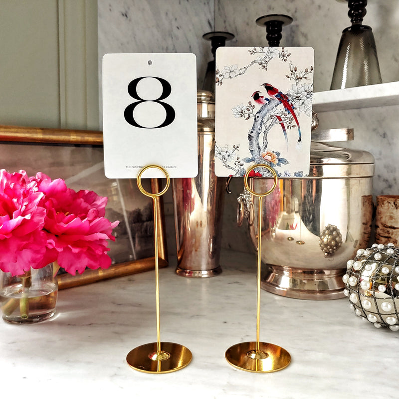The Punctilious Mr. P's Place Card Co. custom Wedding Table Number cards on a tall gold stand
