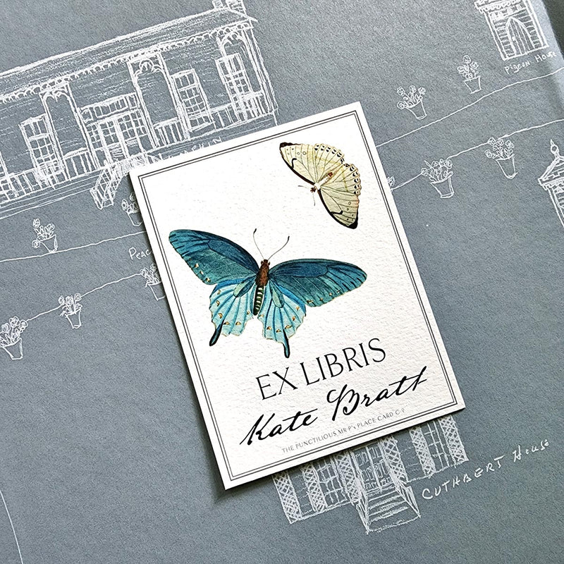 The Punctilious Mr. P's Place Card Co. personalized "blue butterflies" motif bookplate in the "Ex Libris" style.