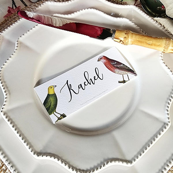 The Punctilious Mr. P's Place Card Co. 'Chromatic Cuckoo' laydown size custom place cards on white china tablescape