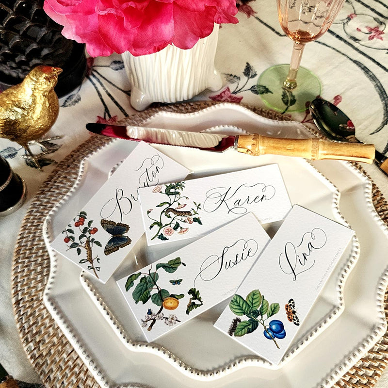 showing all 4 of The Punctilious Mr. P's place card co. 'SIgns of Spring' laydown size custom place cards on a white china tablescape