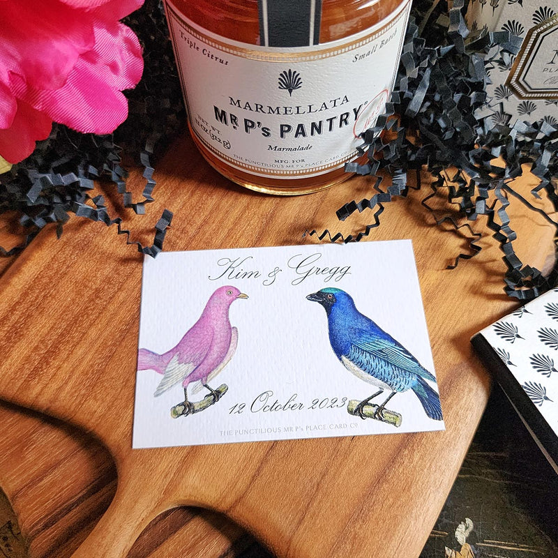The Punctilious Mr. P's Place Card Co. "Chromatic Cuckoo" Custom Gift Notes on a chinoiserie table with marmalade jam, cutting board and fresh flowers