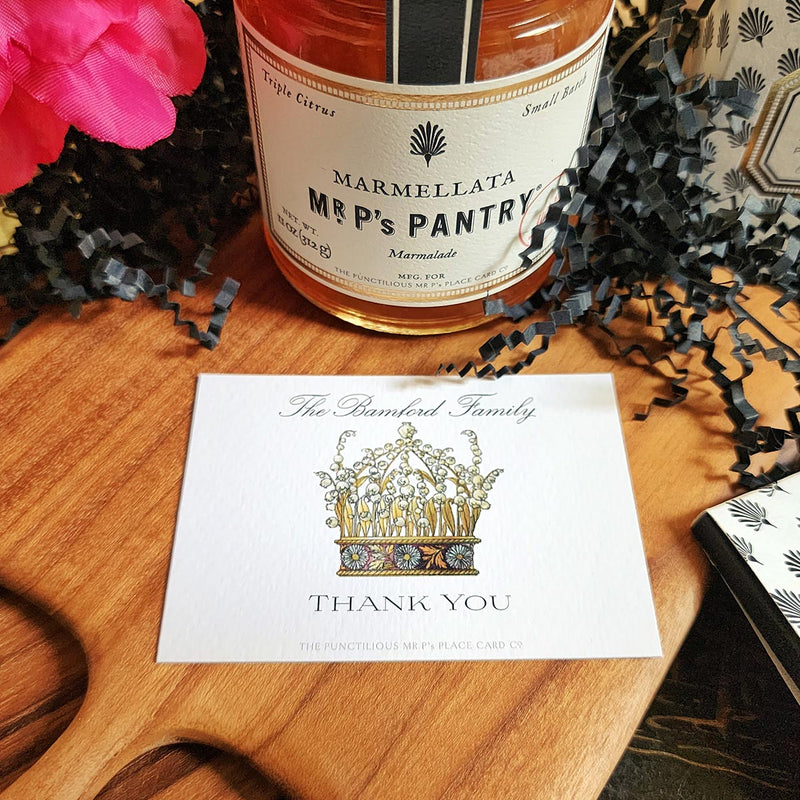 The Punctilious Mr. P's Place Card Co. "Coronet Nouveau" Custom Gift Notes on a chinoiserie table with marmalade jam, cutting board and fresh flowers