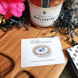 The Punctilious Mr. P's Place Card Co. "The Lover's Eye- Pearl" Custom Gift Notes on a chinoiserie table with marmalade jam, cutting board and fresh flowers