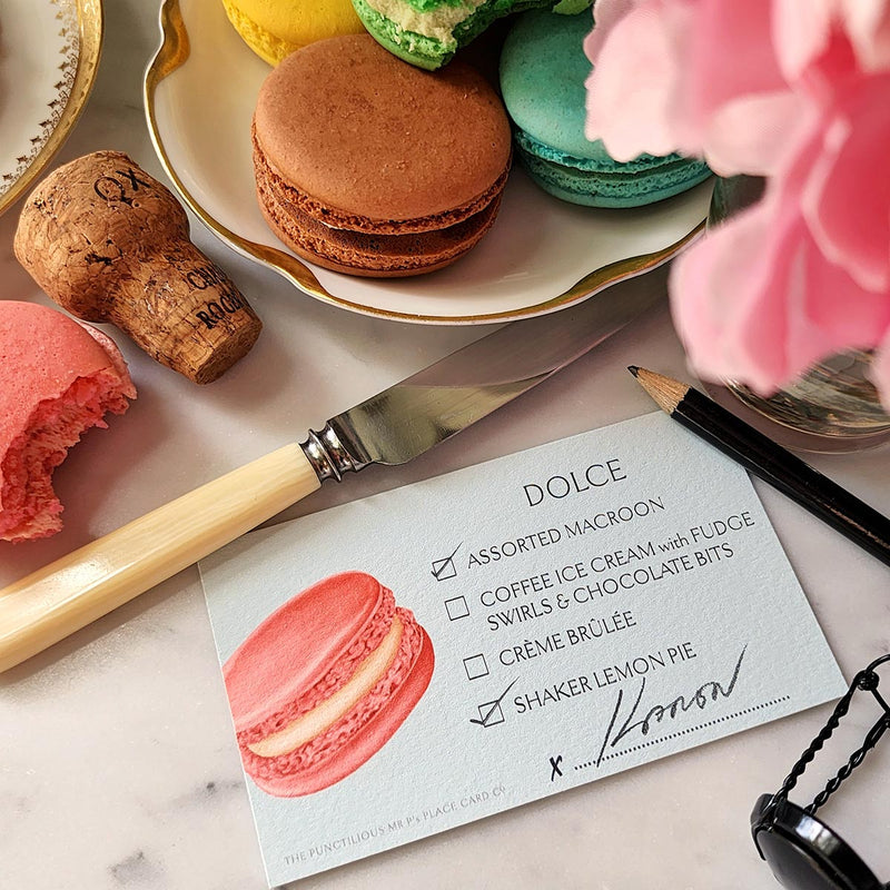 The Punctilious Mr. P's Place Card Co. Macaroon and  Cookies Dessert cards on a marble table with peony and and a dish with stacked macaroons