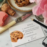 The Punctilious Mr. P's Place Card Co. Macaroon and Cookies Dessert cards on a marble table with peony and and a dish with stacked macaroons