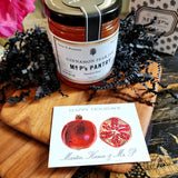 The punctilious mr. p's place card co. "pomegranate" custom gift note on teak cutting board with cinnamon pear jam in the background
