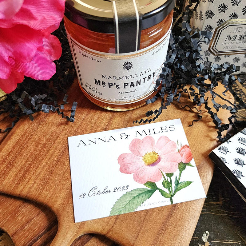 The Punctilious Mr. P's Place Card Co. "Rose Garden" Custom Gift Notes on a chinoiserie table with marmalade jam, cutting board and fresh flowers