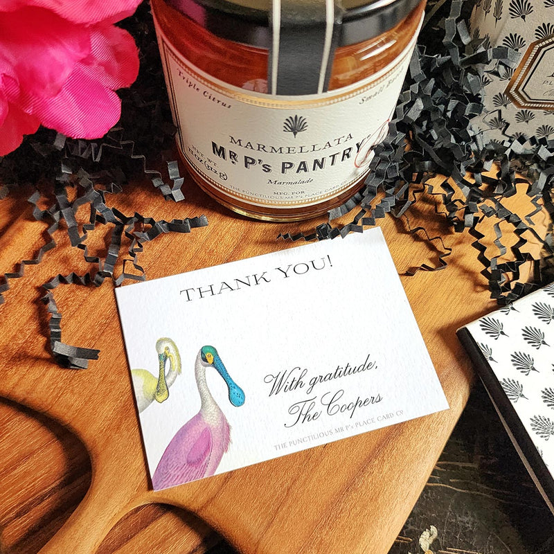 The Punctilious Mr. P's Place Card Co. "Spoonbills" Custom Gift Notes on a chinoiserie table with marmalade jam, cutting board and fresh flowers
