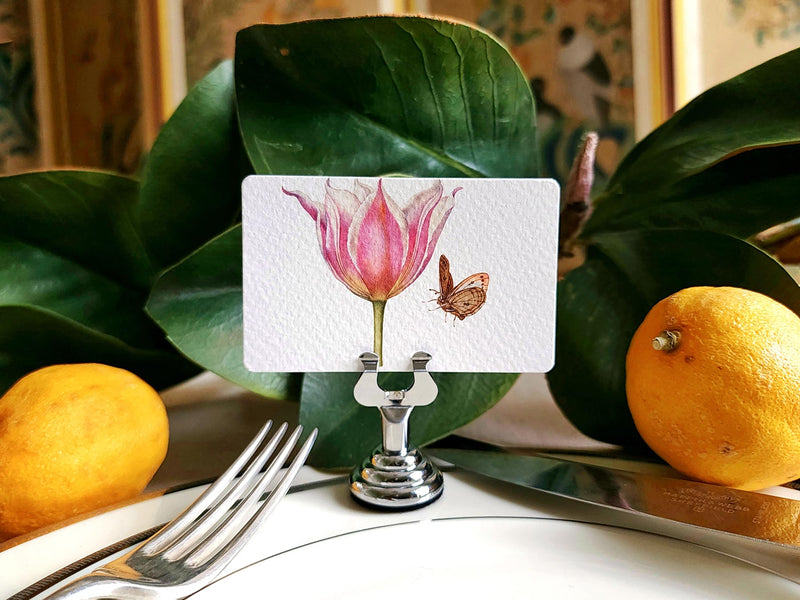 Mr. P's blossoms illustrated place cards on a simple tablescape with fresh lemons and magnolia leaves