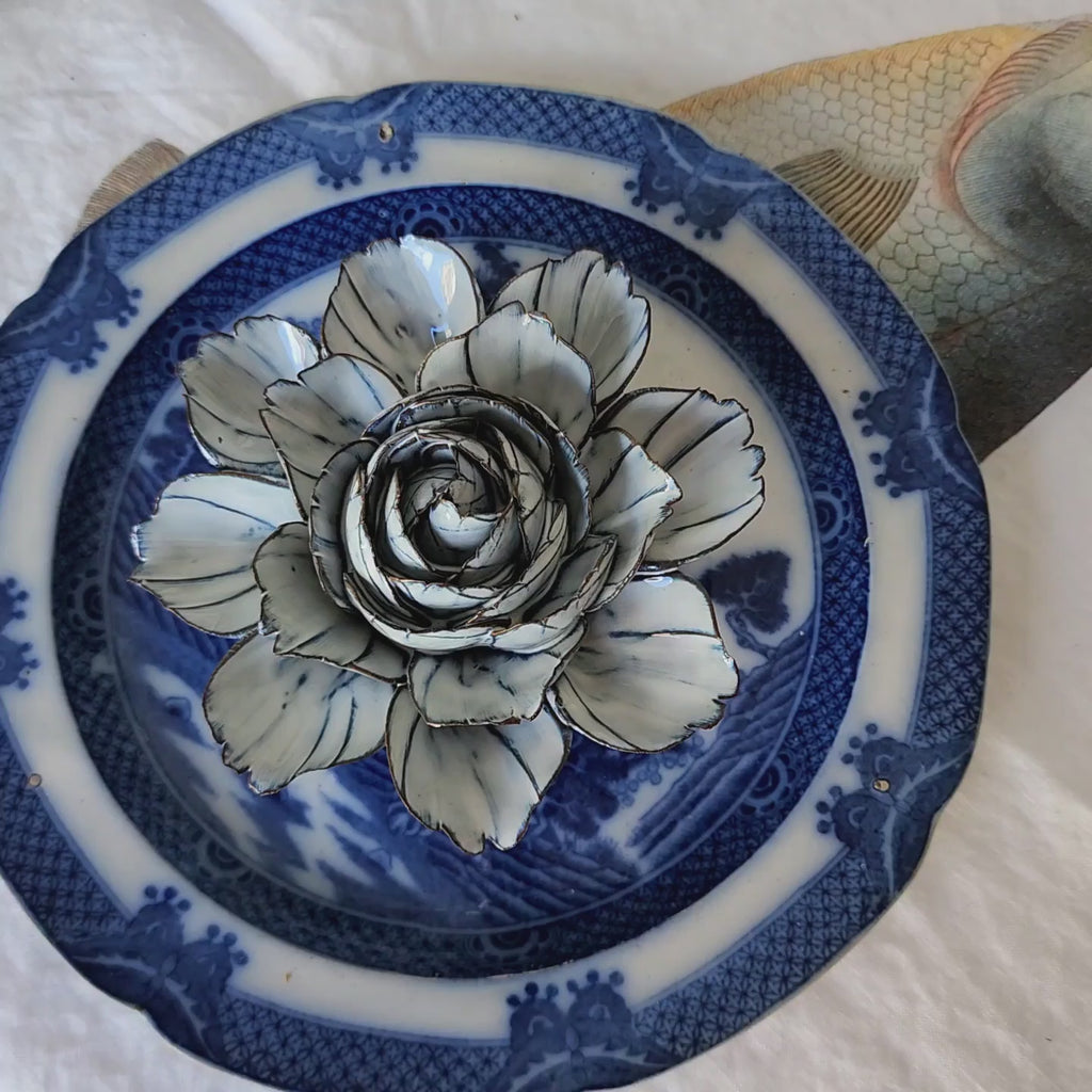 video of Handcrafted blue-and-white ceramic camellia blossom with navy-tipped petals from The Punctilious Mr. P's Place Card Co.