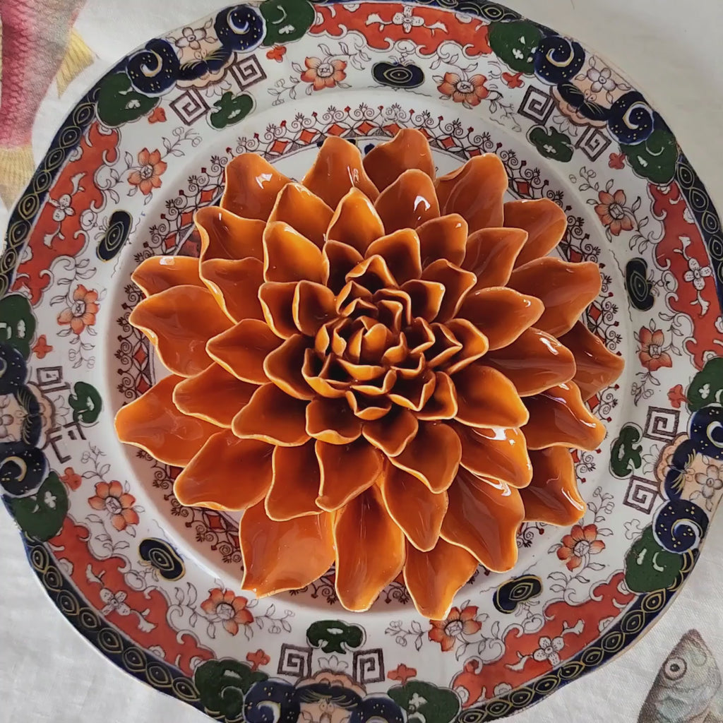 Handcrafted rust-glazed ceramic dahlia blossom with tightly layered petals from The Punctilious Mr. P's Place Card Co.