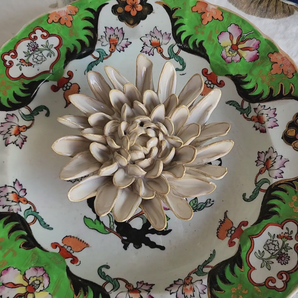 video of Handcrafted ivory ceramic chrysanthemum blossom with golden-tawny petal edges from The Punctilious Mr. P's Place Card Co.
