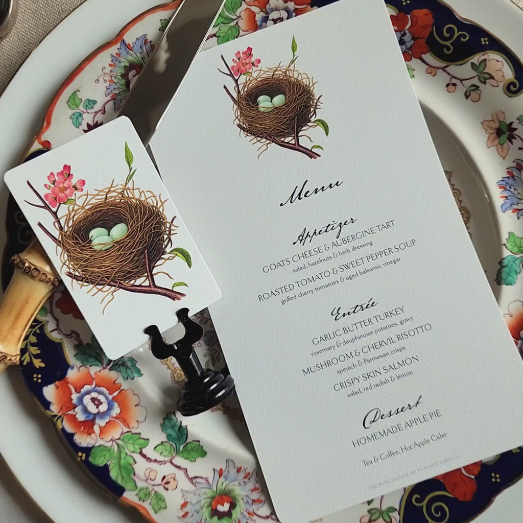 video of Custom menu showing Robin's Eggs laid on a decorative plate with a place card of the same theme beside it.