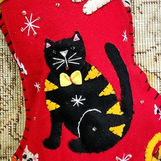 detail  of THE PUNCTILIOUS MR. p's place card co. calico kitty christmas stocking of a black cat