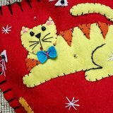 detail of THE PUNCTILIOUS MR. p's place card co. calico kitty christmas stocking of a yellow cat