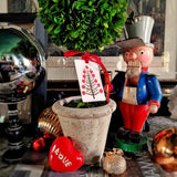 The Punctilious Mr. P's Place Card Co X Marian McEvoy holiday Custom  gift tags of christmas ornaments and a tannenbaum tree on a wooden toy soldier