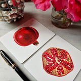 The Punctilious Mr. P's place card co. 'pomegranate' custom note card set on marble ledge with peony flower and fountain pen showing both full and sliced pomegranate