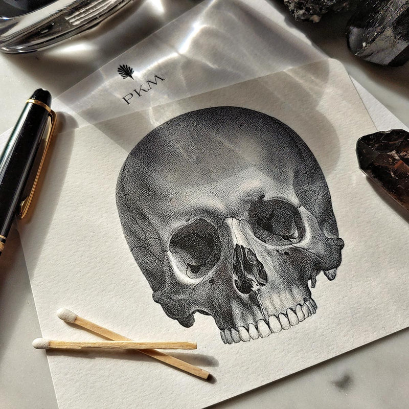 The Punctilious Mr. P's place card co. 'The Skull' custom note card pack with crystals laid around it, with personalized initials on the card