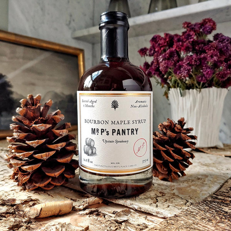 a bottle of The Punctilious Mr. P's Pantry Speakeasy bourbon maple syrup