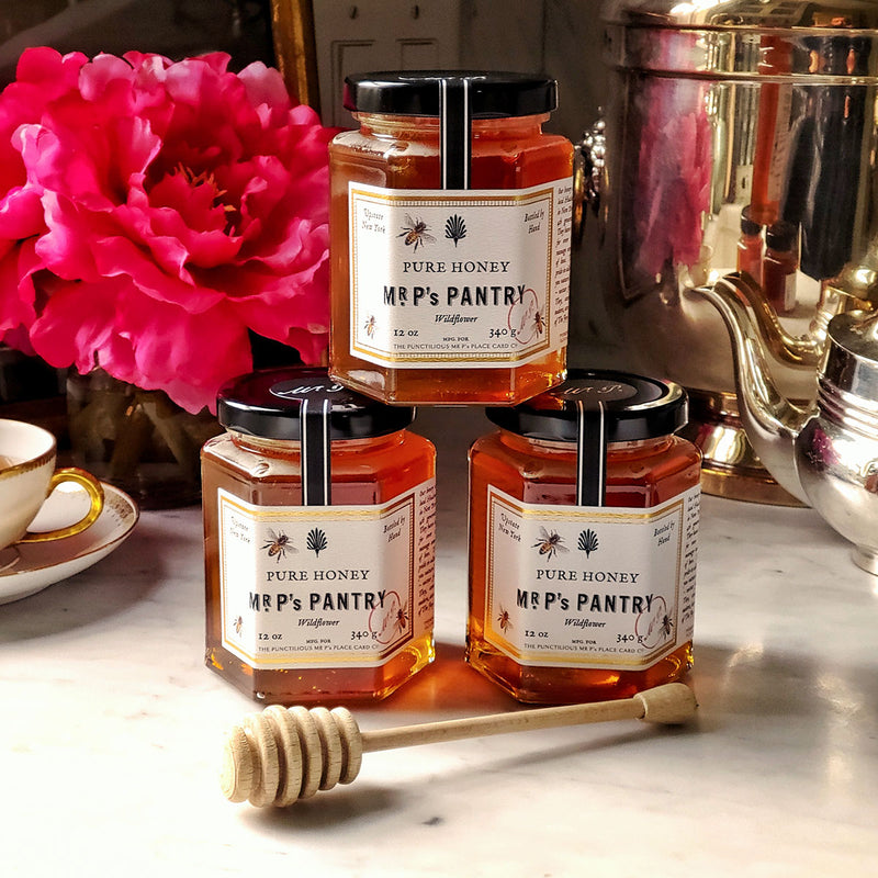 Mr. P's Pantry showing jars of pure wildflower honey with tea pot and gold trimmed tea cup
