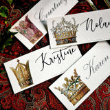 all four of The Punctilious Mr. P's Place Card Co. 'Coronet Nouveau' laydown custom place card on top of paisley tablecloth