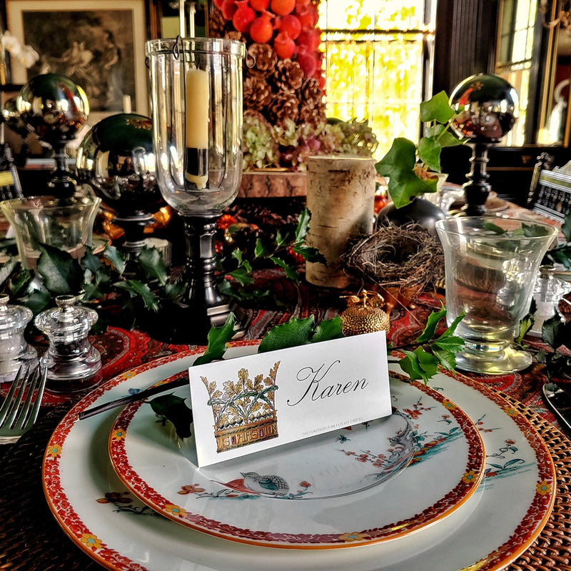 The Punctilious Mr. P's Place Card Co. 'Coronet Nouveau' laydown custom place card on top of chinoiserie dinner plate christmas tablescape with candles and fine decoration