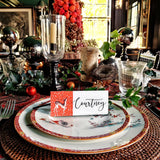 The Punctilious Mr. P's Place Card Co. 'Reindeer games' laydown custom place card on top of chinoiserie dinner plate christmas tablescape with candles and fine decoration