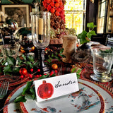 The Punctilious Mr. P's Place Card Co. 'Pomegranate' laydown custom place card on top of chinoiserie dinner plate christmas tablescape with candles and fine decoration