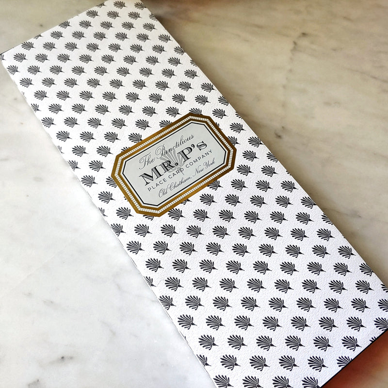 Pack of The Punctilious Mr. P's Place Card Co. menu cards wrapped in their signature anthemion pattern with gold frame label.