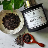 The Punctilious Mr. P's Jasmine black Tea canister with loose tea in saucer