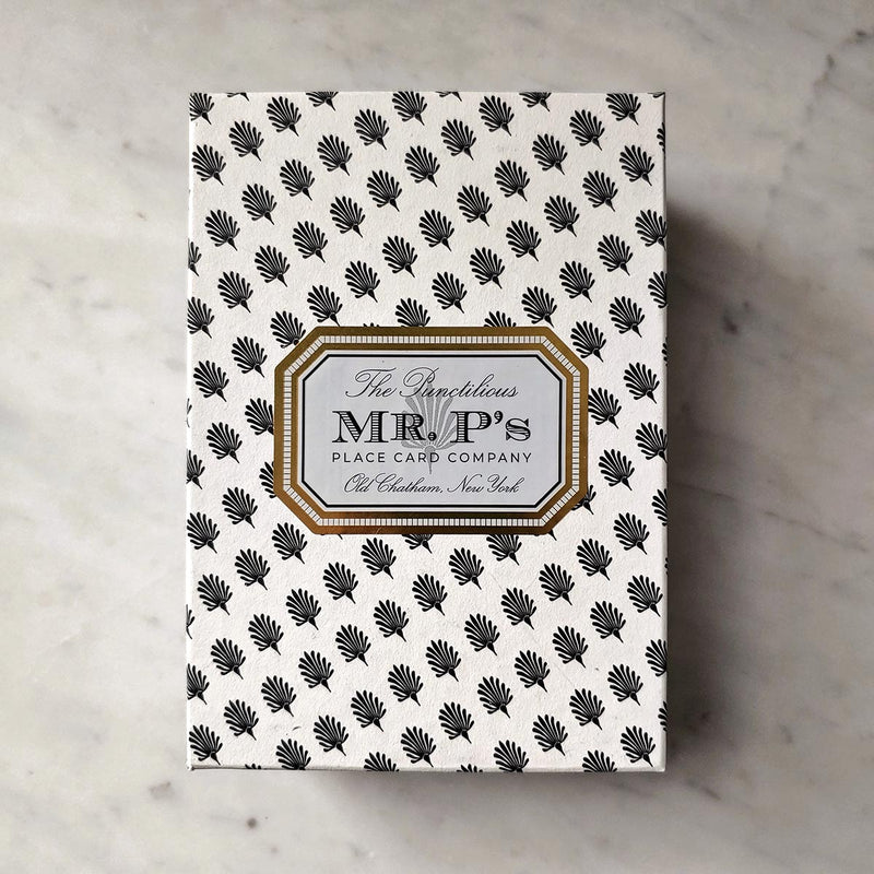 The Punctilious Mr. P's Gift Box wrapped in the house anthemion pattern with gold frame label