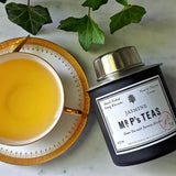 The Punctilious Mr. P's Jasmine Green Tea canister with tea cup and saucer