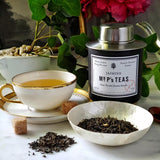The Punctilious Mr. P's Jasmine green Tea canister with tea cup and saucer and loose tea sitting in a white ceramic bowl