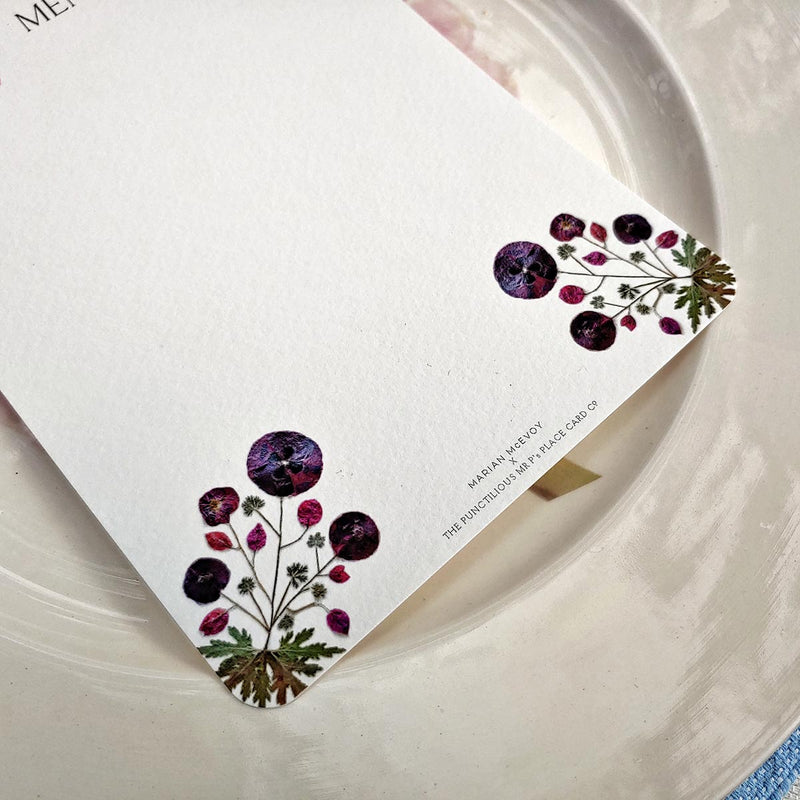 bottom Detail of Marian McEvoy's blank mayfair size pressed poppy custom menu sits atop Christopher Spitzmiller's 'Dahlia' dinner plate