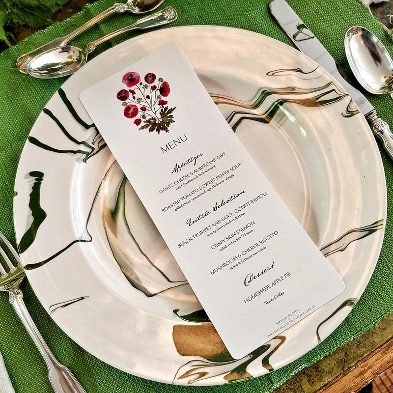 Marian McEvoy's bistro size pressed poppy Custom  menu sits atop Christopher Spitzmiller's green marbleized dinner plate