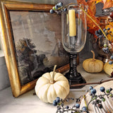 The Punctilious Mr. P's place card co. pantry corner with white pumpkins, a candle and gold frame showing a landscape painting