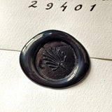 detail of The Punctilious Mr. P's place card co. anthemion design embossed in wax on back of envelope