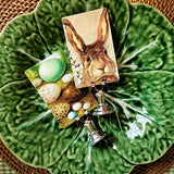detail of the punctilious Mr. P's Place Card Co. Hippity Hoppity illustrated custom place cards of a bunny and eggs on a green majolica plate