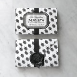 A front and back view of a pack of Mr. P's Place Cards with their iconic black and white anthemion pattern