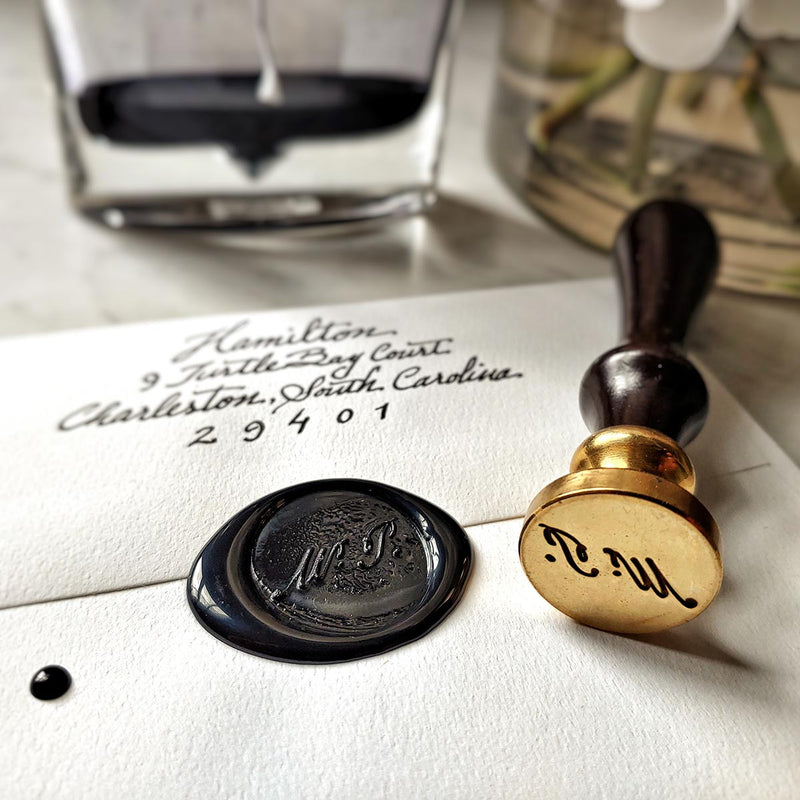 The Punctilious Mr. P's Place Card Co. signature wax seal, ink bottle and beautiful vase of peony flowers