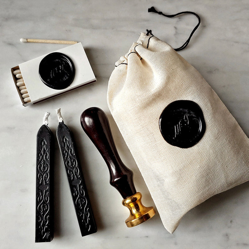 The Punctilious Mr. P's Place Card Co. wax sealing kit with wooden handle and brass seal, 2 black wax sticks, box of matches and muslin pouch