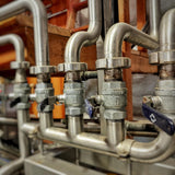 a network of steel distillery pipes and valves at Harvest Spirits Distillery