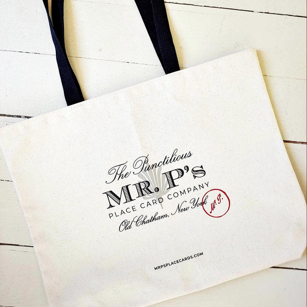 The Punctilious Mr. P's Everyday natural colored canvas tote bag with mr. p logo on front with black web handle